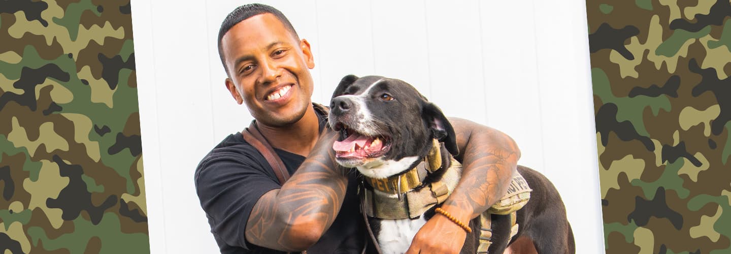 Veteran hugging a service dog