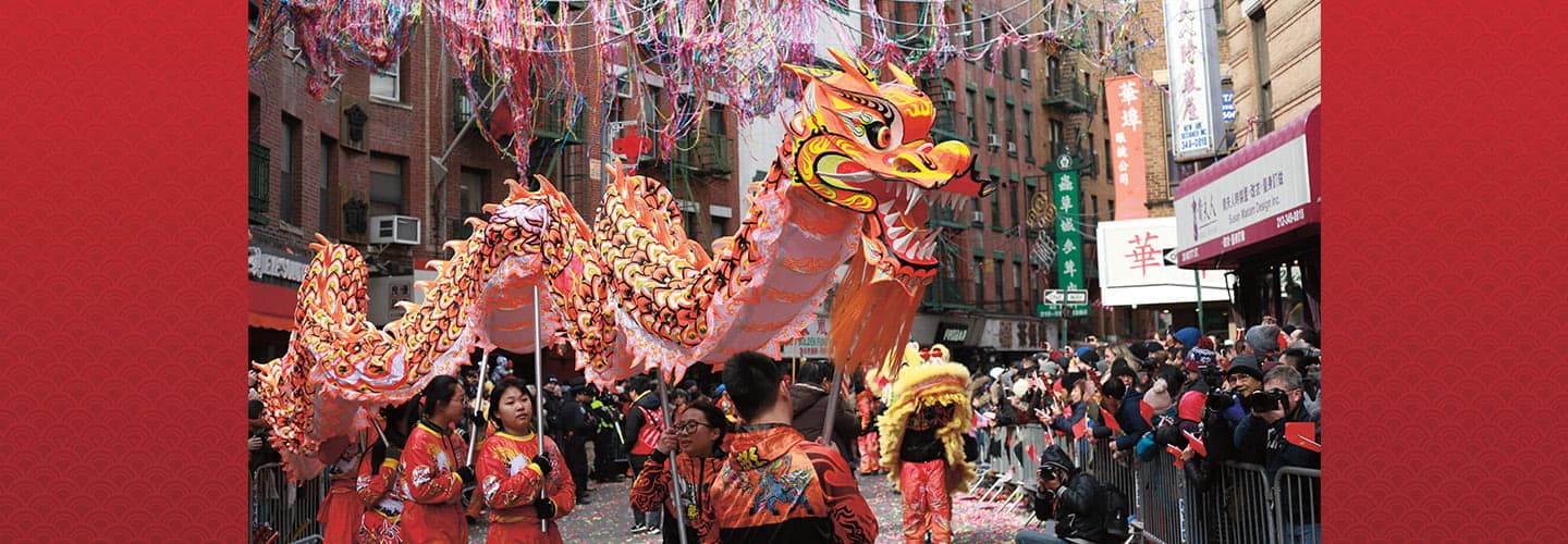 Photo of people holding up a Chinese dragon during a parade