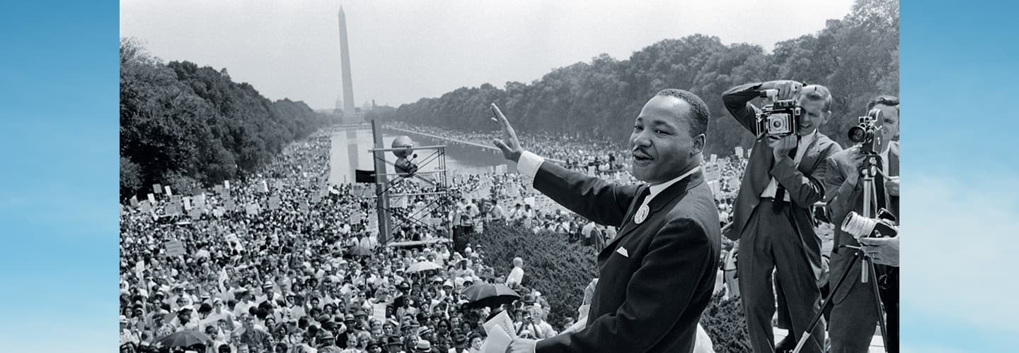 Black & white photo of MLK Jr. delivering a speech in Washington D.C. in front of huge crowd